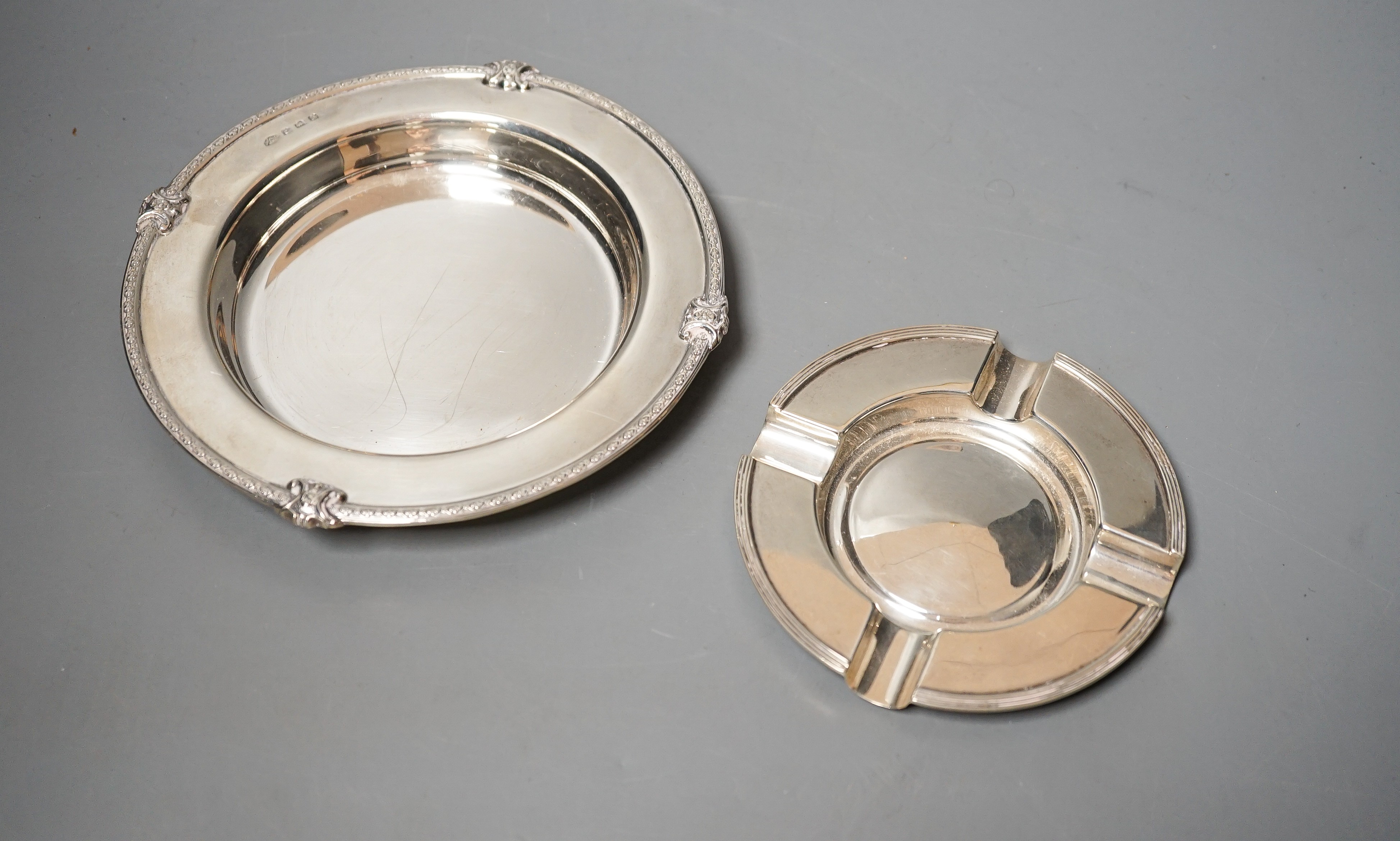 A George V silver shallow dish or stand, Adie Bros. Birmingham, 1927, 16.2cm and a silver ashtray, 11oz.